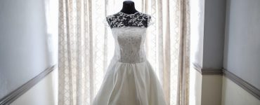 wedding dress in front of curtains