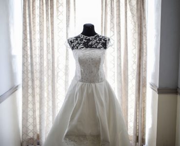wedding dress in front of curtains
