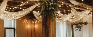 A wedding venue adorned with simple yet elegant decorations, including string lights, greenery, and a cozy ambiance highlighting budget-friendly elegance.