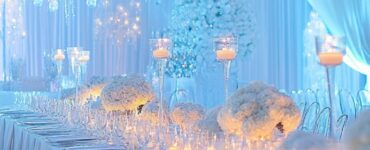 Elegant winter wedding decorations in hues of white, silver, and icy blue, creating a magical and romantic ambiance in a beautifully adorned venue.