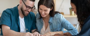 couple signing a wedding insurance policy
