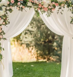 A romantic wedding ceremony setup featuring a beautifully decorated arch as the focal point.
