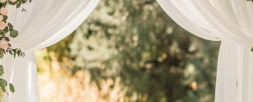 A romantic wedding ceremony setup featuring a beautifully decorated arch as the focal point.