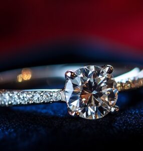 Close-up of a sparkling diamond engagement ring resting on a velvet box, symbolizing love and commitment.