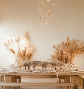 A minimalist wedding setup featuring wooden furniture, soft lighting, and natural decor, embodying eco-conscious choices.