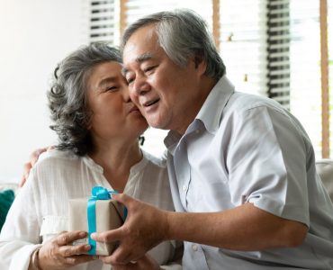 older couple exchanging gifts