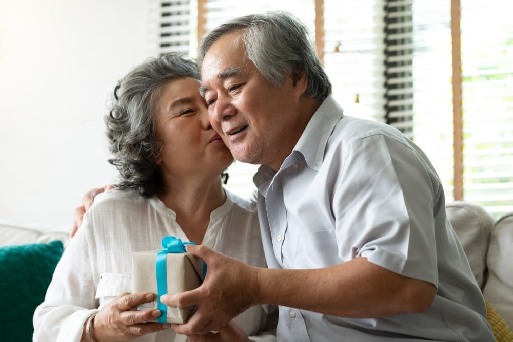 older couple exchanging gifts