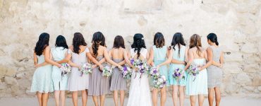 bride and bridesmaids holding hands