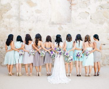 bride and bridesmaids holding hands
