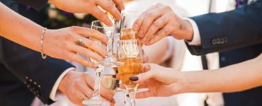 wedding guests toast at cocktail party