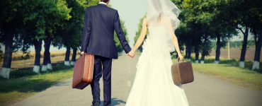 bride and groom with suitcases