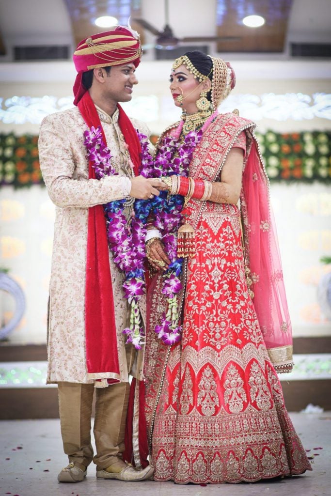 indian wedding couple wearing traditional Indian wedding attire