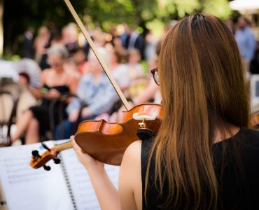 woman playing violin at wedding