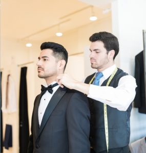 man trying on tuxedo