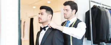 man trying on tuxedo