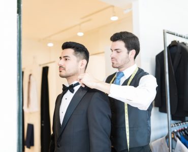 man trying on tuxedo