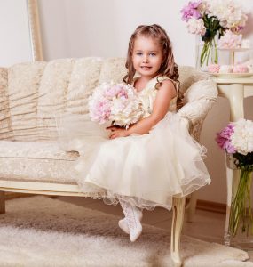 flower girl sitting on couch