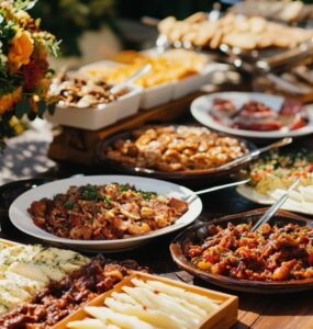 A spread of diverse wedding foods, including classic dishes and unique servings, designed to spark conversation among guests.