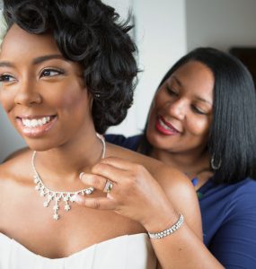mother of the bride helping bride get ready