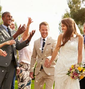 couple and guests at summer wedding