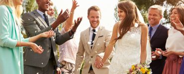 couple and guests at summer wedding