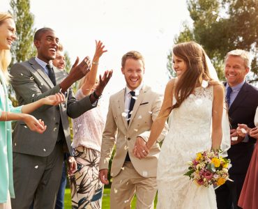 couple and guests at summer wedding