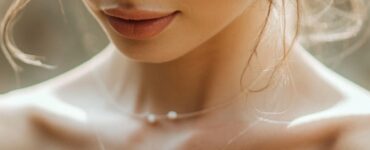 A bride wearing an elegant off-the-shoulder wedding dress, highlighting her neckline and shoulders with delicate lace detailing.
