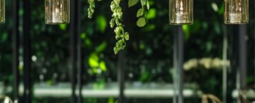 A vibrant emerald green-themed wedding setup featuring elegant table decor, floral arrangements, and stylish attire, creating a bold and sophisticated atmosphere.