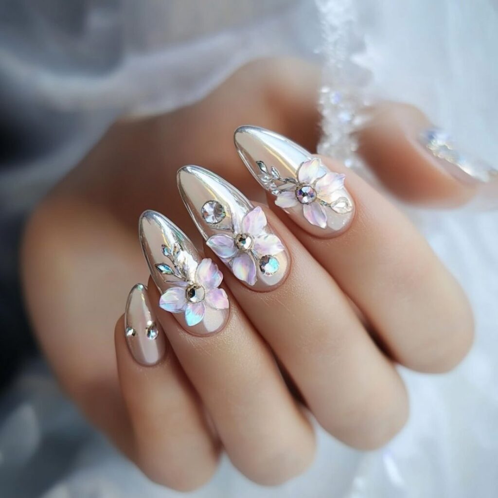Romantic wedding nails with delicate floral chrome designs on a soft pastel base, perfect for a feminine bridal look.