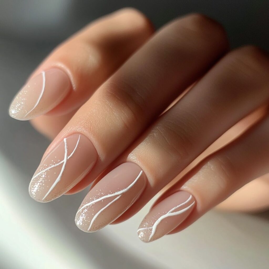 Close-up of elegant minimalist wedding nails featuring a nude base with delicate white lines and subtle sparkle accents.