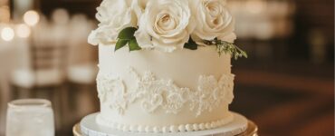 An elegant small wedding cake, showcasing refined design and attention to detail, serves as a beautiful focal point at a wedding reception, adding sophistication and a personal touch to the celebration.