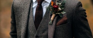 Groom dressed in stylish fall wedding attire, featuring rich colors, textures, and layers, to ensure a confident and timeless appearance.