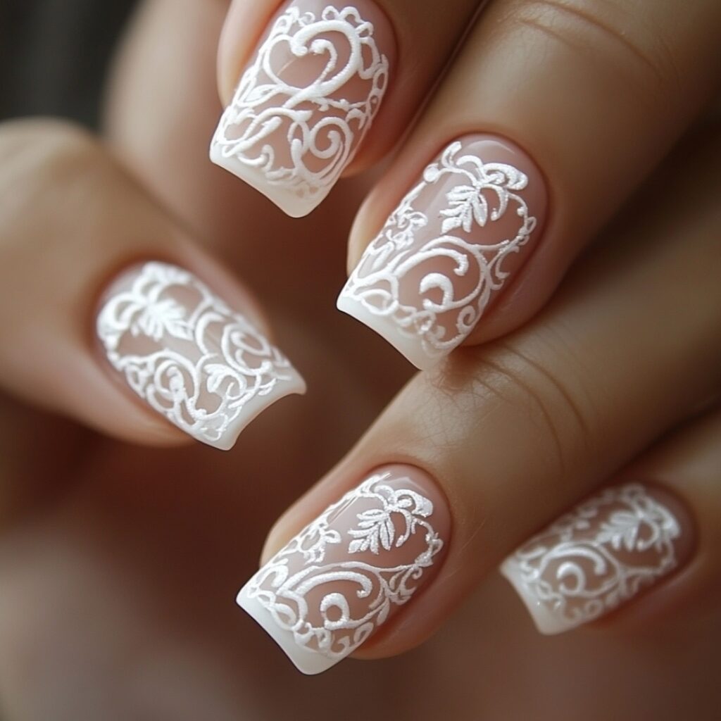 Exquisite nails showcasing a French manicure with intricate lace designs, perfect for brides with vintage or classic-themed weddings.