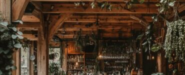 Image of a rustic barn wedding venue showcasing cozy, natural elements like wooden beams, lush greenery, and charming decorations that create a relaxed yet stylish atmosphere.