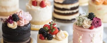 An assortment of beautifully designed mini wedding cakes, each customized to match different wedding themes, showcasing their visual appeal and delicious variety.