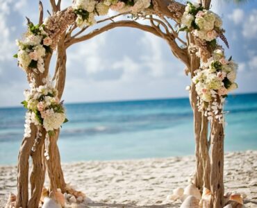 Create a magical and unforgettable beach wedding with driftwood arches, seashell garlands, and tropical flowers that capture the ocean's beauty and serenity.