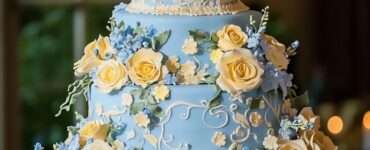 A beautifully decorated blue and yellow wedding cake enhances the wedding's visual appeal and offers a variety of flavors, reflecting the couple's love story.