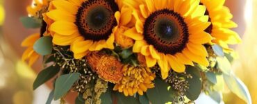 Sunflowers, symbolizing happiness and warmth, make a meaningful addition to fall weddings with their bold colors and rustic charm, enhancing the joy and coziness of the celebration.