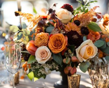 A fall wedding celebration incorporating natural elements, seasonal décor, warm beverages, and interactive entertainment to create a cozy, memorable experience reflecting the magic of autumn.