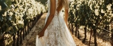 A bride standing in a vineyard, showcasing a beautiful wedding dress that complements the natural scenery, capturing the essence of elegance and personal style.