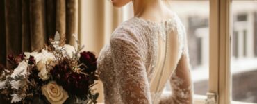 A bride showcasing a variety of elegant December wedding dresses, from luxurious velvet and shimmering sequins to delicate lace, perfect for a magical winter ceremony.