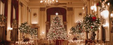 A beautifully decorated ballroom featuring sparkling lights, rich holiday colors, and elegant decor for a timeless Christmas wedding celebration.