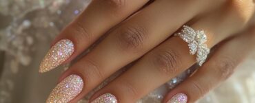 Close-up of bridal hands with festive, glittering nails, ideal for a New Year’s wedding, showcasing elegance and celebration-ready style.