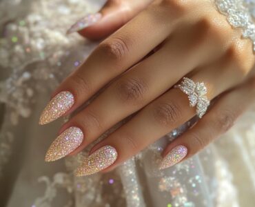 Close-up of bridal hands with festive, glittering nails, ideal for a New Year’s wedding, showcasing elegance and celebration-ready style.