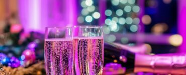 A festive New Year’s wedding reception setup with sparkling decorations, champagne, and vibrant lighting, blending romance and celebration to welcome the new year.