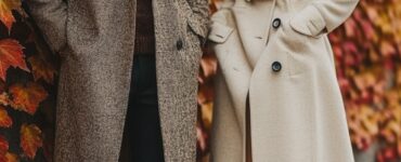 A stylish couple preparing to attend an October wedding, showcasing coordinated outfits that reflect seasonal charm, with layers and playful accessories to enhance their look.
