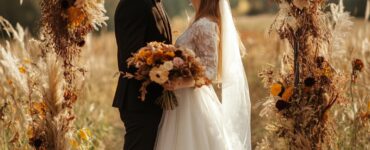 A picturesque autumn landscape featuring a beautiful couple celebrating their love at an October wedding, surrounded by seasonal decor and vibrant fall colors.