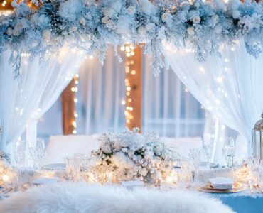 A beautifully decorated winter wonderland wedding featuring frosted décor, winter florals, cozy luxurious touches, and sparkling lights, creating an enchanting and unforgettable experience for guests.