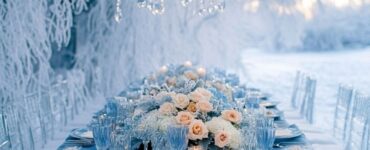 Winter wedding setup with elegant blue color palette, featuring shades of frosty pastels to deep navy blues against a snowy, sparkling landscape.