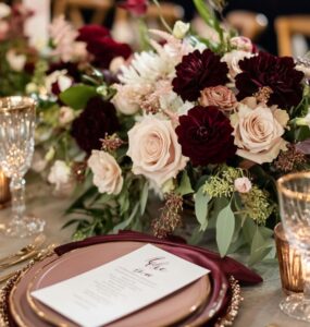 Stunning burgundy color palette with gold, blush, and navy accents, creating an elegant and cozy atmosphere for a winter wedding.